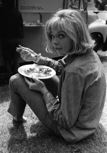 Susannah York takes a lunch break during the filming of scruggs shot outside block of