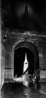 00086 Prints: Through the suspension bridge arch under which two girls shelter All Saints Church