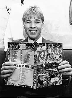 00607 Prints: Swansea City footballer Andy Legg holding a football programme ahead of his side