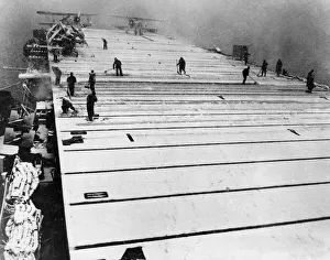 Russia Prints: Sweeping the snow covered flight deck of the British escort carrier HMS Fencer during a