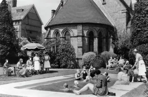 Health Prints: Swimmers laze in the sun by the outdoor pool at Rubery Hill Hospital, Birmingham