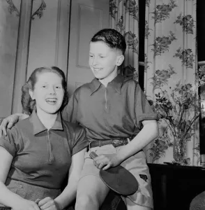 Table Tennis Prints: Table Tennis Family. Mother and her son pose with bats February 1953