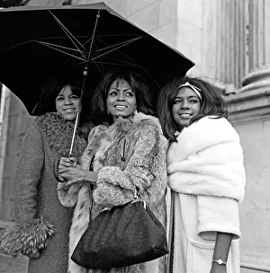 00383 Prints: Tamla Motown Groups Invade London The Supremes share an umrella at Marble Arch