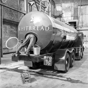 A tanker driver seen here cleaning out the inside of his vehicle at the Whitbread brewery
