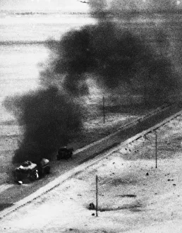 Bombings Prints: A tanker and trailer on fire after an attack from a Blenheim bomber during Second World