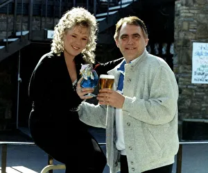 Bill Tarmey actor with Letitia Dean actress hold glasses together