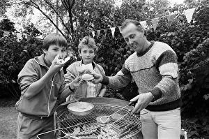 00684 Prints: Tasty... Trying out the hotdogs at a summer fete held in the grounds of Longdenholme old
