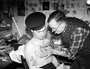 Tattoo Prints: Tattooist applying sailor tattoo to the chest of a sailor on the Royal Navy Circa 1945
