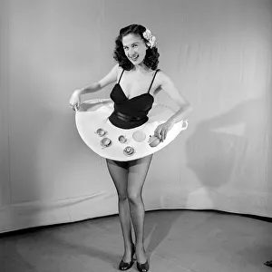 Waitress Prints: Tea for two: Woman wearing tea cup skirt. 1959 E38-004