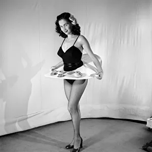 Tea for two: Woman wearing tea cup skirt. 1959 E38-005
