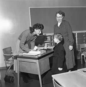 Infant School Prints: Teacher greets a new addition to her class at South Mead School, Southfield, Wimbledon