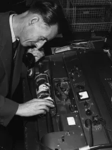 Technician overseeing the transmission of an image in the Telephoto room at the Daily