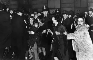 Beatlemania Prints: Teenage fans of The Beatles pop group try to break the police cordon as the band leave