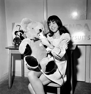 Teenage girl putting the finishing touches to a teddy bear