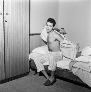Teenage pop idol Cliff Richard relaxes on his divan at his Winchmore Hill home
