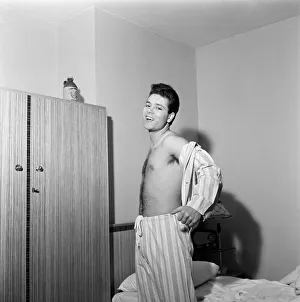 01169 Prints: Teenage pop idol Cliff Richard relaxes on his divan at his Winchmore Hill home