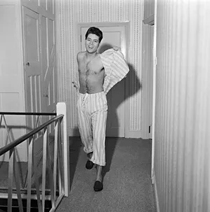 01169 Prints: Teenage pop idol Cliff Richard relaxes on his divan at his Winchmore Hill home