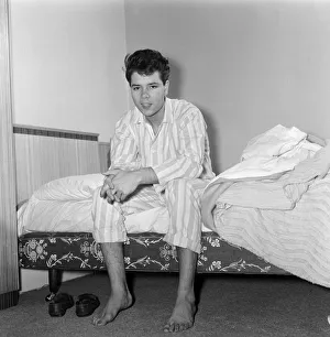 01169 Prints: Teenage pop idol Cliff Richard relaxes on his divan at his Winchmore Hill home