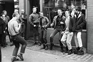1980s Fashion Prints: Teenage Skinheads dancing the Moonstomp outside a shop in London. 29th March 1980