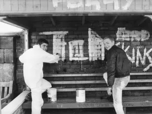Teenagers Alan Quinnin and Bill Hutchinson start the clean-up after vandals wrecked havoc