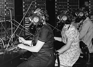 Communication Prints: Telephone girls at Whitley Bay Post Office try out the gas masks as they prepare for any