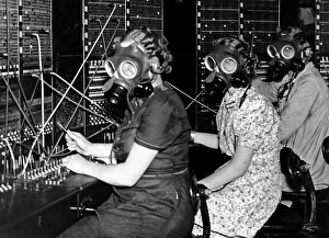 Telephone girls at Whitley Bay Post Office try out the gas masks as they prepare for any