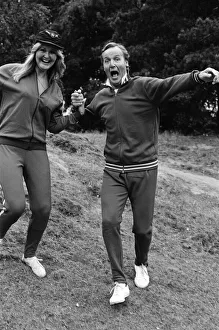 Television personality Nicholas Parsons jogging with his daughter. September 1976
