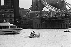 00967 Prints: Television presenter Peter Duncan in a VW Beetle car in the River Thames