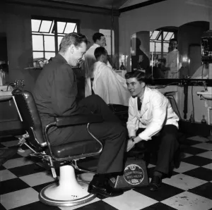 Usaf Prints: Terence O Neill at work as a shoe-shine boy in the barbers shop at the American Air