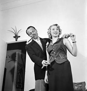 Terry Thomas fits his self adjusting waistcoat on film star Sandra Dorne who Terry