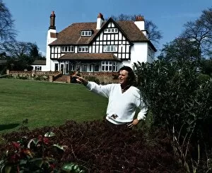 Images Dated 13th December 1988: Terry Wogan Radio and TV Presenter stands and points in his garden in front of his house