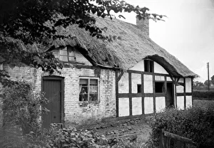 00039 Prints: Thatched roof cottage of Izaak Walton in the village of Shallowford July 1923 Alf