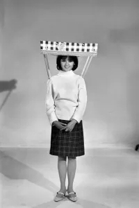 Therese Howard Jones demonstrating the wear-me umbrella. Model. Circa 1959