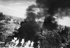 A thick columns of black smoke rising from a Japanese train attacked by Bristol