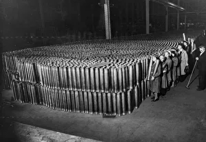 Factories Prints: Thousands of 3. 7 inch Anti Aircraft shell cases stacked up in a munitions factory