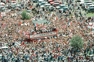 Thousands of England football fans line the streets near Luton airport to welcome their