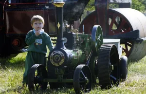 Vintage Prints: Three-year-old Richard Baillie from Forest hall with a miniature traction engine on 13th