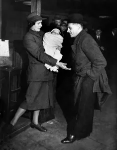 00037 Prints: Ticket collector'. The woman comes to the rescue she is holding the baby