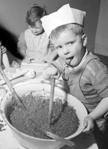 00189 Prints: Timothy Walker seen here stirring the Christmas Pudding at a Bristol Day Nursery