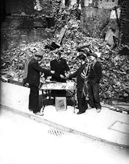 Tobacconist sells cigarettes outside bombed shop during London blitz