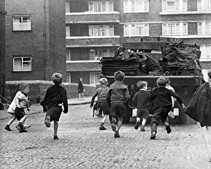 Shorts Prints: Toddlers in Merseyside running after National Coal Board Lorries and trying to jump