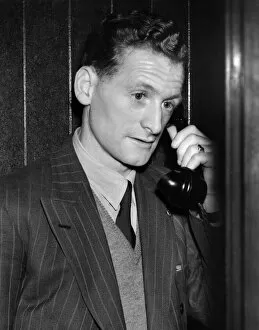 00253 Collection: Tom Finney, who plays on the right wing, seems worried as he makes a midnight phone call