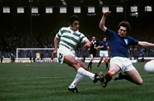 Tom Forsyth of Rangers slides in to try and block a shot by Paul Wilson of Celtic during