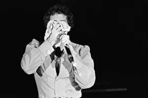 Knickers Prints: Tom Jones in concert in America. Tom wipes his face on a pair of knickers. April 1983
