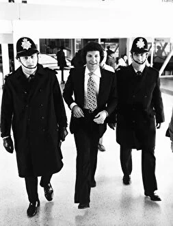 Images Dated 13th March 1972: Tom Jones Pop Singer being escorted by Police at Heathrow Airport
