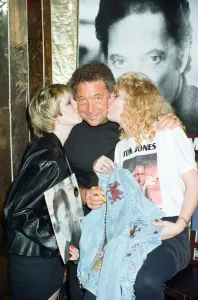 Tom Jones poses with fans Kathy Hall and Rosina Sims at HMV Oxford Street
