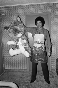 Tom Jones poses with presents from fans at Westbury Music Festival, just outside New York