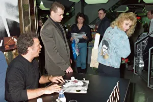 01341 Prints: Tom Jones signs the knickers and jacket of his fan Kathy Hall at HMV Oxford Street