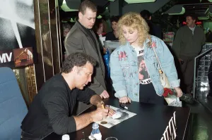 01341 Prints: Tom Jones signs the knickers and jacket of his fan Kathy Hall at HMV Oxford Street