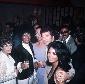 Tom Jones Singer chats with some members of the American pop group the 5th Dimension at a